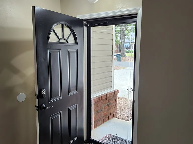 Immediate front door entrance; modern entrance light; beautifully painted black front door and entrance; very welcoming.