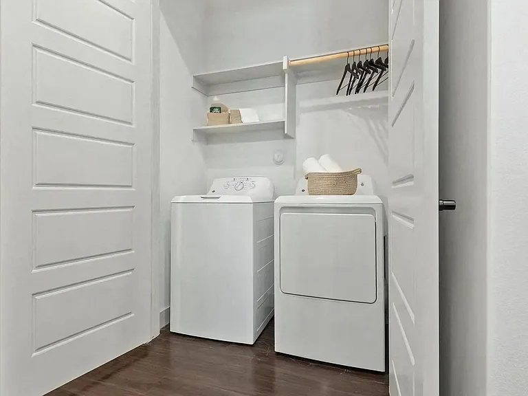 In-Unit Laundry with Washer, Dryer, and Overhead Shelving