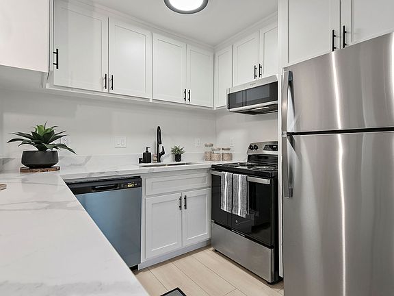Experience effortless cleanup with a deep kitchen sink and a sleek pull_down sprayer faucet designed for maximum convenience.