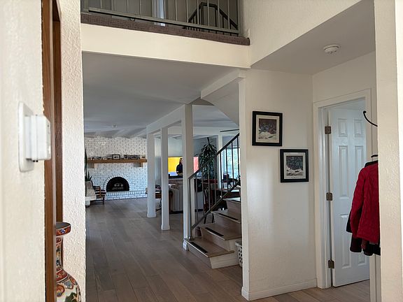 Door leading to bathroom, open space dining/living area. Leftside leads to bedroom and kitchen.