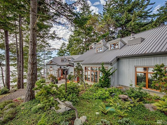 Designed by Craig Webster, the northwest contemporary home blends seamlessly into the artistically designed landscape.  