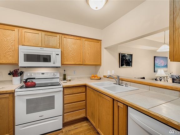 An abundance of cabinetry and tile countertops providing plenty of food prep space.