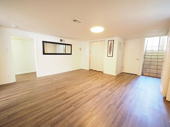 Living/ dining room facing the front door (right), the laundry closet (middle) and the hallway (left)