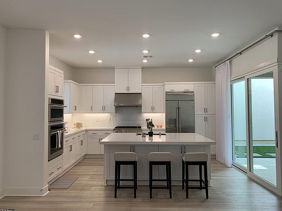 Light and Bright kitchen with dual sliding doors that open to the Linai