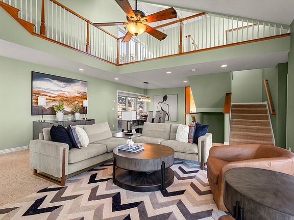 Open concept living to dining area--premium Palliser sectional and Hooker tables.
