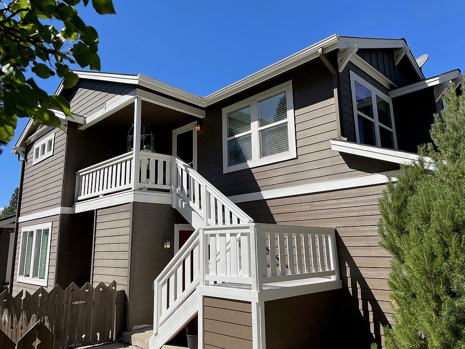 Exterior with parking space. Unit is at top of stairs.