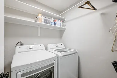Laundry room on 1st floor off of kitchen comes with new washer and dryer plus area for handing clothes and storing cleaning supplies