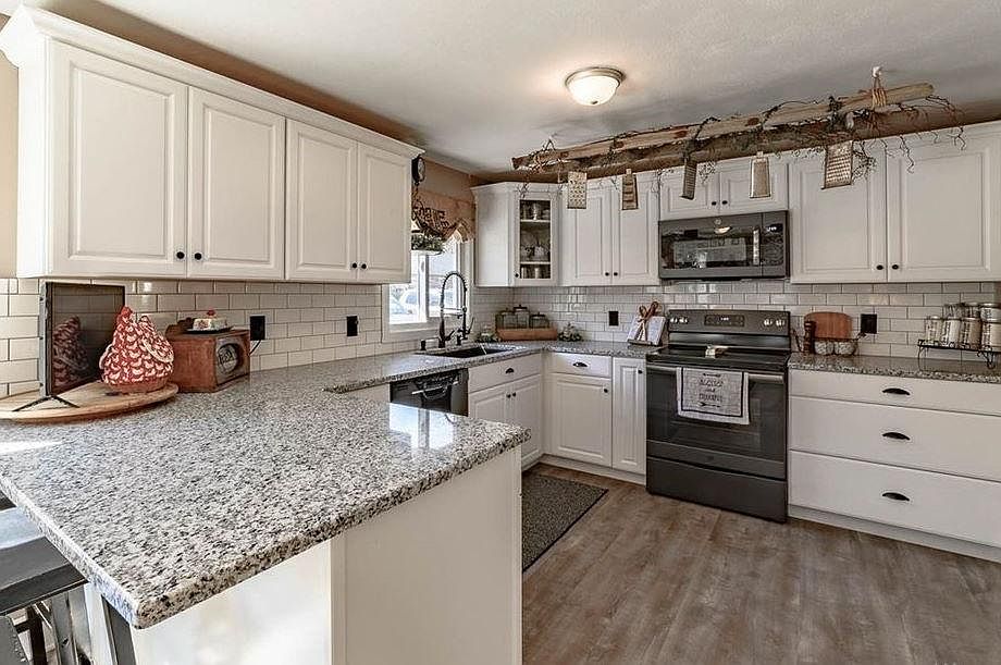 Spacious new kitchen with high-end fixtures, quartz countertops and undermount sink.