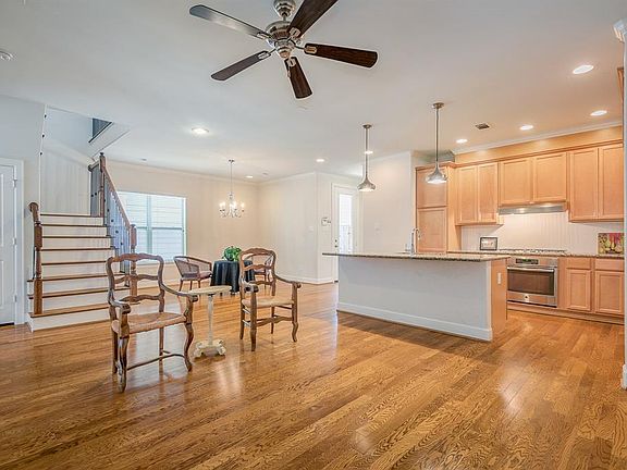 OPEN INTO DEN, KITCHEN AND EATING AREA WITH ALL WOOD FLOORS