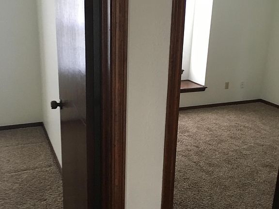Two side by side bedrooms with bench seats at windows