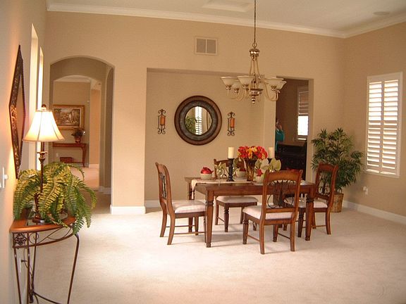 Spacious formal dining, plantation shutters adorn many windows