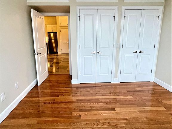 Bedroom 1 with Hardwood Flooring Double Closets and Over head storage. Lots of Natural Light. With Blackout Shades