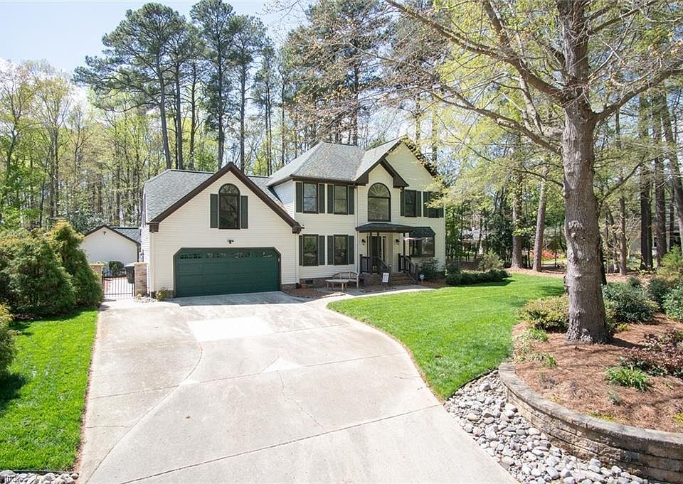 Large driveway & Thoughtful Landscaping accent this impressive home.