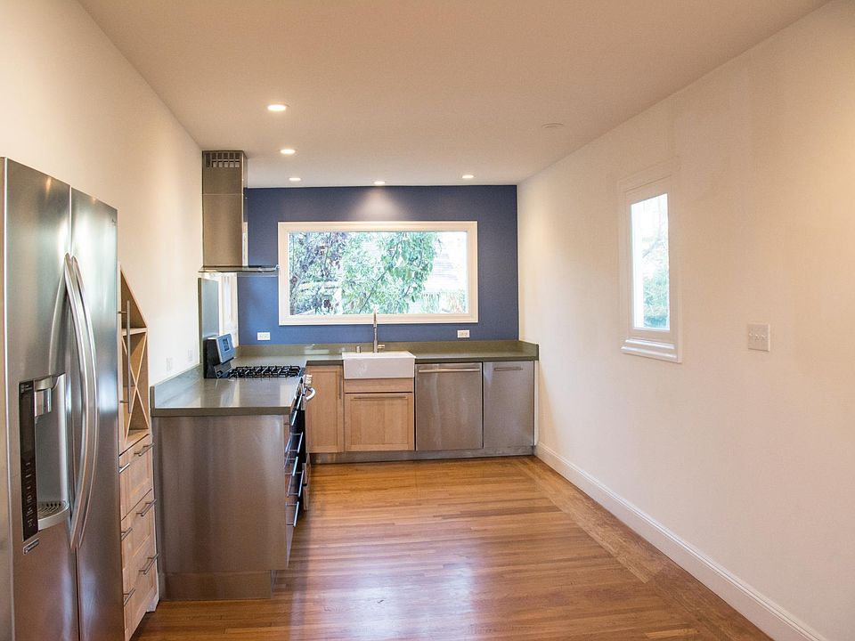 Open living area includes professional kitchen, window looks onto back yard
