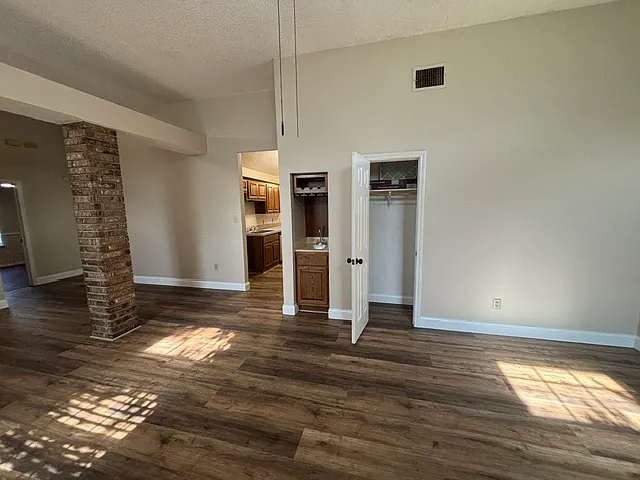 living area with coat closed and bar