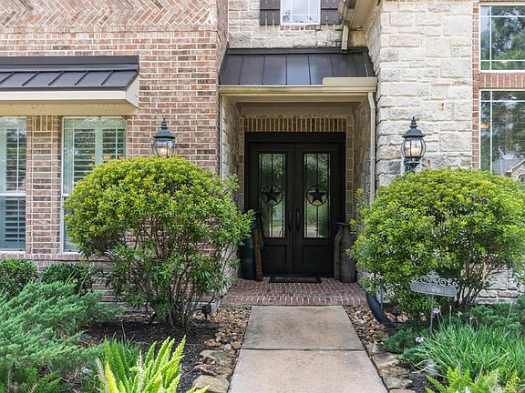 Stunning double wrought iron doors greet you as you enter the property.