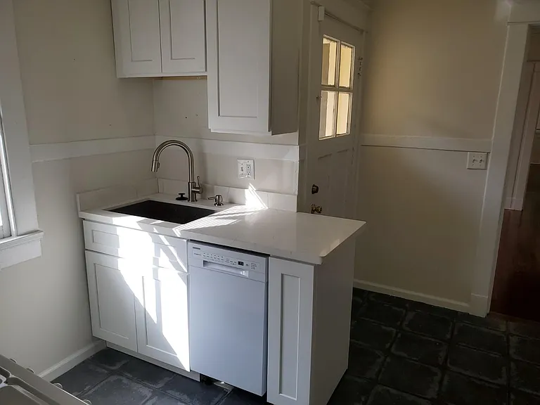 Kitchen sink and dishwasher- also side entrance from driveway