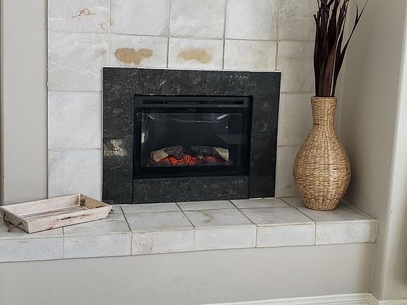 Marble fireplace with Electric fire box and remote control. (color/heat, etc)