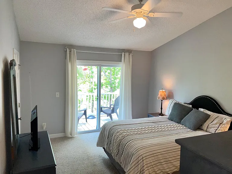 Main upstairs bedroom with covered balcony