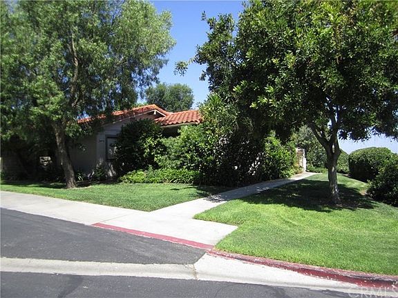 View of front of property including public parking space close to front door
