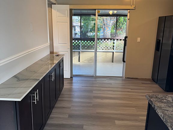 Generous added cabinetry offers valuable extra storage, with sliding glass doors opening to the screened porch for a bright open feel.