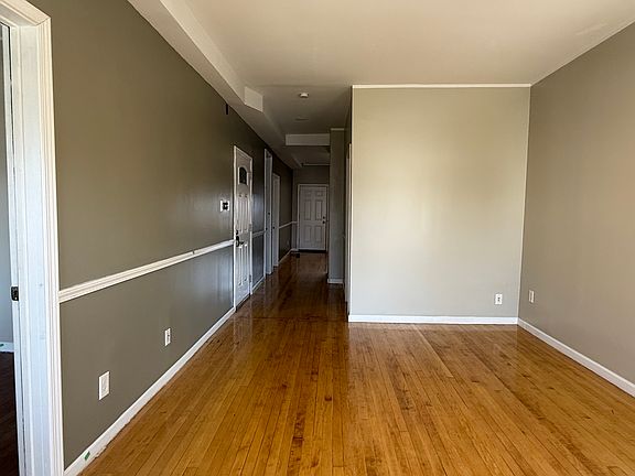 Living room view of hallway leading to kitchen.