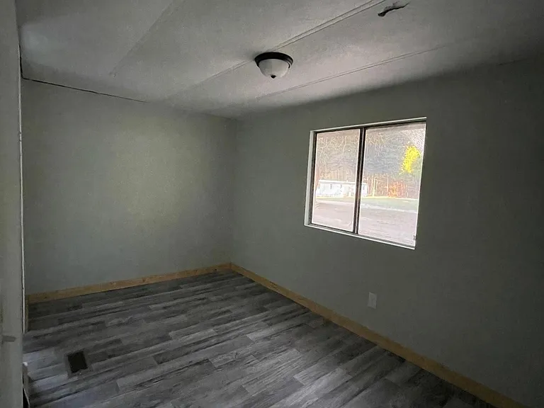 Freshly primed/painted, new light fixtures, flooring in far guest bedroom.