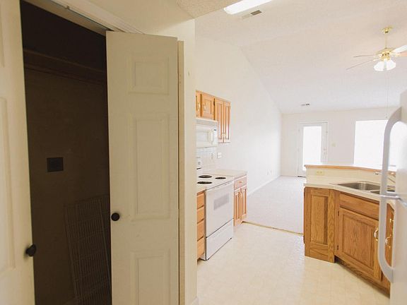 View of kitchen and washer/dryer area from garage entrane