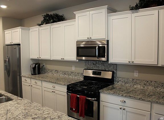 Another view of the kitchen. Notice there's' no shortage of counter space. Beautiful white cabinets with plenty of storage.