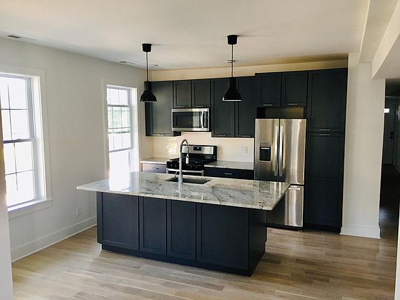 Oversized kitchen island complete with lots of lower cabinet storage