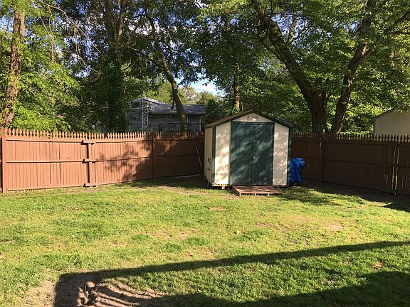 Fenced backyard with shed.