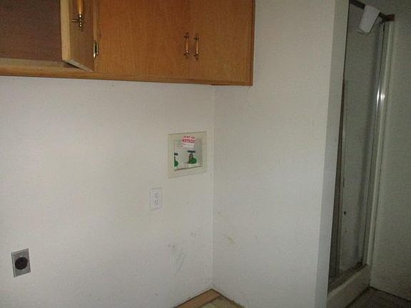 laundry with extra shower stall