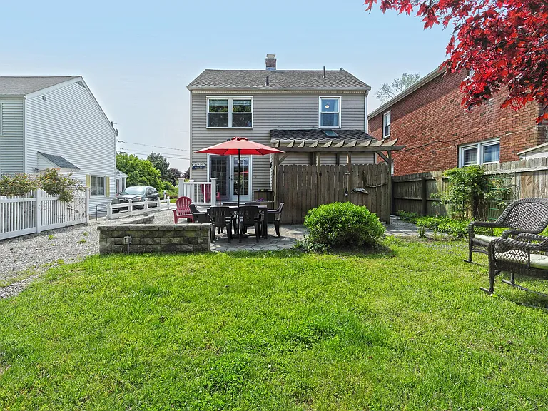 Rear yard with paver patio table and chairs.