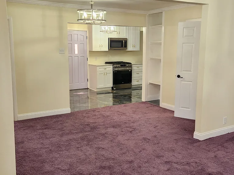 Kitchen includes gas stove, microwave, fridge