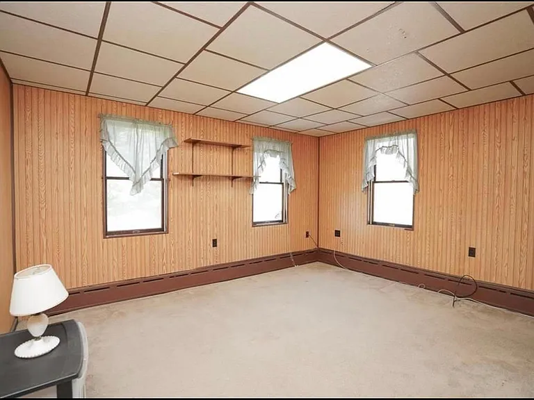This lovely bedroom has a pocket door, and a nice-sized closet, windows on two sides look out to the yard.