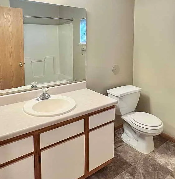 Get ready with ease in your full bathroom featuring a wide vanity, built-in storage, and a convenient tub-shower combo.