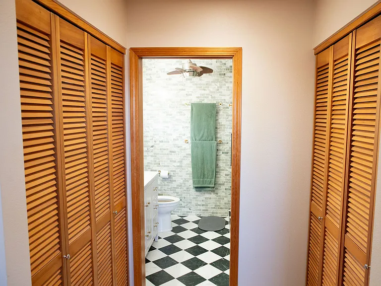 Primary bedroom, dual closets & bathroom