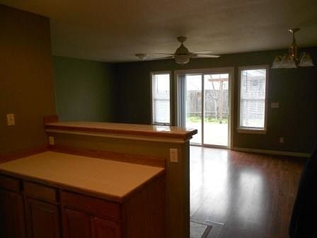 Laminate flooring in living room with sliding glass door to