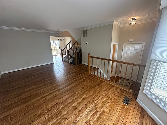 Living Room looking towards dining room in back of house. Newly refinished hardwood floors!