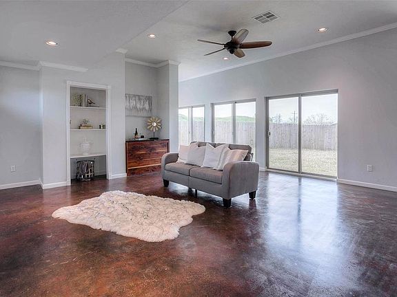 Living area features sliding glass doors to access backyard.