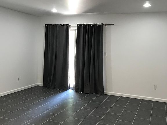 Living room with double slider overlooking patio and locked storage closet.