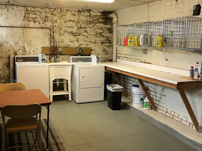 Basement laundry area. Each resident has their own basket for laundry items such as detergent etc.