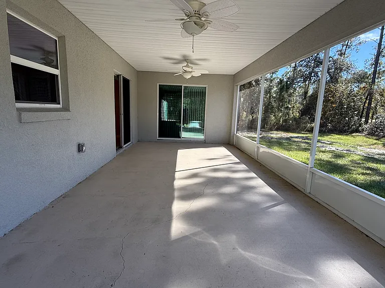 Screened in lanai with outdoor fans.
