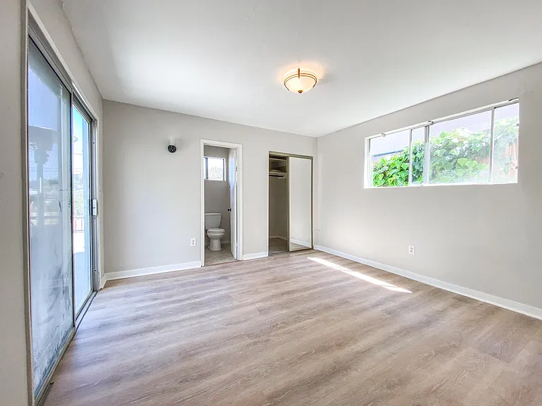 The master bedroom sits away from the rest of the house down the long hallway but it also has its own entrance to the outside.