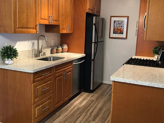 Remodeled Kitchen with Quartz Countertops and stainless steel appliances.