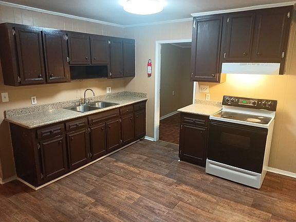 Kitchen with new granite counters and new vent hood.
