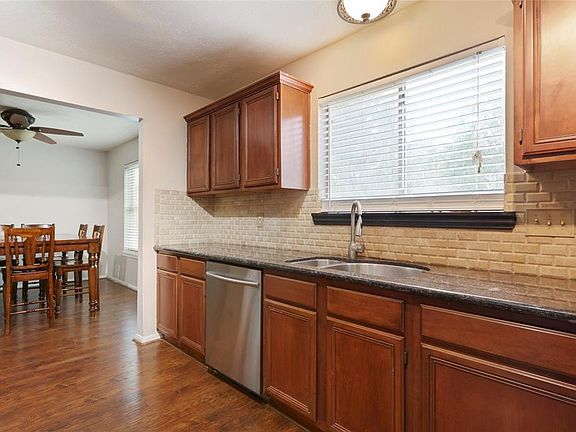 Nice window above the sink, into the empty slate backyard.