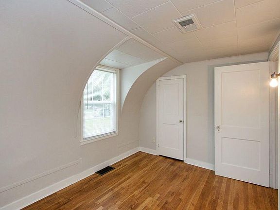 Main floor bedroom with hardwood floors.