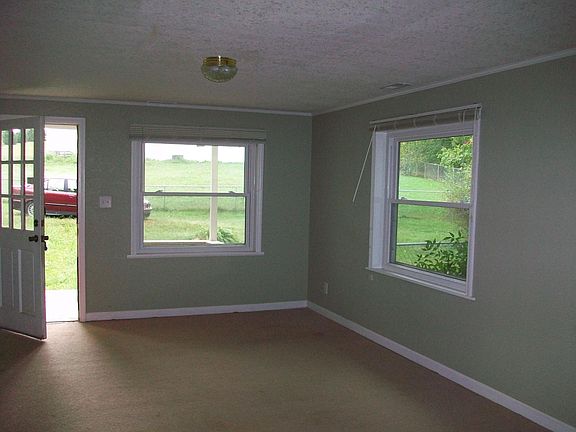 Standing in kitchen, looking toward front door and yard.