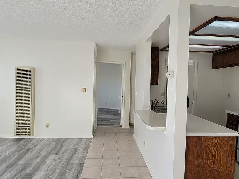 Living room, Kitchen, dining area and entrance door to the bedroom.